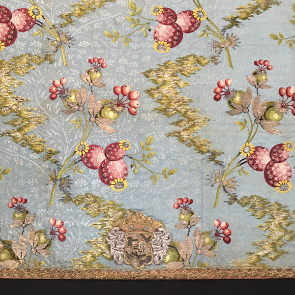 detail 18th century silk brocade mounted with crest